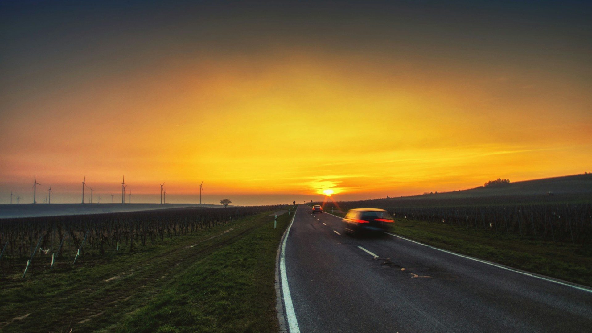 black car on road during sunset